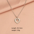 Silver stainless steel heart pendant necklace on pink fabric, 45+5cm length, 3.9g weight - Silver Small Hollow Heart Style (LT001MP696)