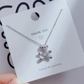 Detail of silver bear pendant with micro-pave crystals and heart-shaped center gem - Zircon Heart Bear