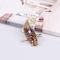 Fish resin sculpture with gold foil and purple crystal stone on an open book - Amethyst