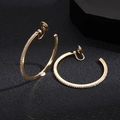Macro view of gold hoop clip-on earrings with pavé rhinestones on black background - Clip-On Earrings / 4cm / Gold
