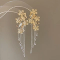 Detail of gold flower and butterfly earrings with long metal chain tassels and crystal drops - Silver Needle Gold Flower