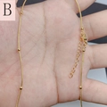 Detail view of gold snake chain with beads featuring lobster clasp and extension chain - Bead Snake Chain