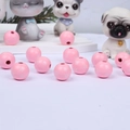 Macro detail of pink round wooden beads with white paw prints for DIY jewelry crafting - Pink Base White Paw