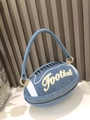 Detailed macro view of denim rugby ball handbag featuring gold Football embroidery - Denim Blue A