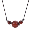 Macro detail of natural red agate pendant with silver metal accents on black cord necklace - Agate - Necklace