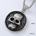 Detail view of a 33mm silver skull pendant showing the size, weight, and metallic texture - Round Punk Skull (Style 17)