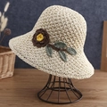 Close-up of handmade crochet straw hat featuring 3D brown flower and green leaf detail - Beige
