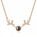 Detail of rose gold reindeer antler pendant with black projection stone and zircon accents - Doe Antler Rose Gold