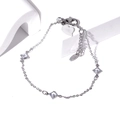 Macro view of silver bracelet with diamond-cut zircons, lobster clasp and heart charm - Rhombus Zirconia Silver
