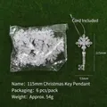 6-pack of transparent acrylic key-shaped Christmas ornaments with silver cords on green moss - Christmas Key Ornament / 115mm