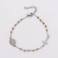 Detail of silver rosary bracelet with golden beads, cross pendant and Mary medal - Gold & Silver