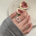 Detail of twisted 925 silver ring worn by hand with fresh fig and ceramic plate background - J5254 Cross Cutout Lines Silver
