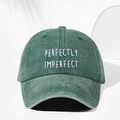 Adjustable washed green baseball cap featuring white Perfectly Imperfect embroidery - Dark Green