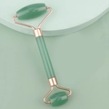 Detail of dual-head jade facial roller with rose gold frame on a minimalist pedestal - Resin Double Head Roller Green