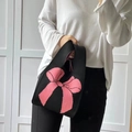 Knit tote bag in classic black featuring a large pink bow graphic and soft texture - Black And Pink Bow