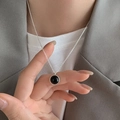 Elegant silver necklace featuring a black round onyx pendant worn with a grey blazer - Black Round Stone Style (XL2670)