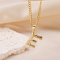 Golden necklace featuring a textured letter E pendant with natural lava-like surface finish - Gold Letter E (Pendant Only)