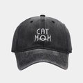 Detailed view of white CAT MOM embroidery on washed black cotton baseball cap fabric - Adjustable / Black