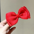 Close-up of red mesh hair bow with silver sparkles and soft fabric texture - Red