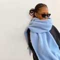 Soft light blue mohair scarf with tassels for winter, showcased on a model side view - Light Blue