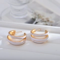 Elegant triple-layered gold hoop earrings with white enamel finish for a chic look - White