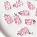 Macro detail of translucent pink resin gummy bear charms with metal jewelry loops - Pink