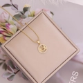 Macro detail of 18K gold-plated zodiac pendant with micro-pave crystals on a gift box - 3#Gemini