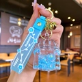 Light blue castle liquid quicksand keychain with star sequins and silicone wrist strap - Blue Luminous Bubble Bead Castle