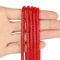 Detail of hand holding multiple strands of 4x2mm vibrant red abacus beads for DIY jewelry - 150 Pieces / Red Coral
