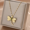 Elegant gold dragonfly pendant necklace with green gemstone and white zircon on jewelry box - Gold Yellow