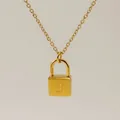Macro shot of gold padlock necklace pendant with elegant letter B engraving - Letter B Style