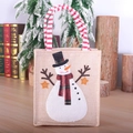 Weihnachtliche Jute-Geschenktüte mit Schneemann-Motiv und rot gestreiften Griffen - Schneemann