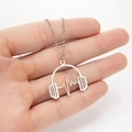 Detailed close-up of a silver headphone and heartbeat line pendant on a link chain - Silver Headphones