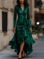 Deep V-neck emerald satin dress with ruffled hem and waist tie shown in city night - Green(105580)