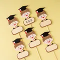 Pack of 60 graduation cake toppers with boy character and writable space for messages - Writable Graduation Boy