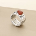 Macro shot of silver knot ring featuring a large red triangular gemstone inlay - 12mm Steel Color Triple Layer Wrap Style (KR110923-K)