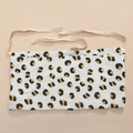 Close-up of cotton muslin crib organizer with animal print and soft ties for hanging - Leopard Print