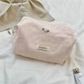 Detailed view of pink corduroy makeup bag featuring lace trim and a 3D fabric rose flower - Pink / Large (22x12x11cm)