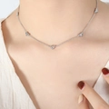 Silver necklace for women with small zircon heart pendants displayed on model - Necklace / 36+5cm / Steel