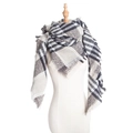Soft bouclé yarn scarf with black, white, and grey plaid patterns and tassel edges - Gray