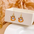 Detail of Halloween pumpkin earrings with skull face on a white decorative box display - Pumpkin Ghost