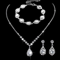 Macro shot of silver bridal jewelry set featuring teardrop crystals on black background - Silver Water Drop Necklace Bracelet Earrings Set (463+799)