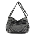 Dettaglio del tessuto denim grigio scuro lavato e delle tasche frontali con zip - Nero