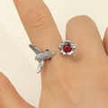 Macro detail of bird and ruby flower open ring in silver metal on model's finger - Hummingbird With Red Rhinestone Style (7744) / Antique Silver