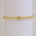Golden beaded stretch bracelet featuring a micro-set letter K charm with clear crystals - Letter K
