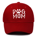 Close-up of white 3D embroidered DOG MOM text and paw print on red cotton baseball cap - Burgundy