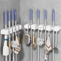 White wall-mounted mop and broom holder with multiple suction hooks on marble wall - 4 Clips 5 Hooks Cream White 2Pcs