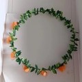 Floral headband with six orange foam roses and green leaves for festive hair styling - Orange
