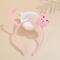 Pink hand-knit headband featuring cute pig character with ceramic cup and soft shadows - Pig