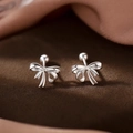 Elegant silver bow stud earrings with screw ball backs on a dark velvet display base - Exquisite Bowknot Style (A234)